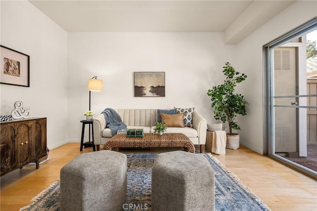 living room with light wood-style flooring and baseboards