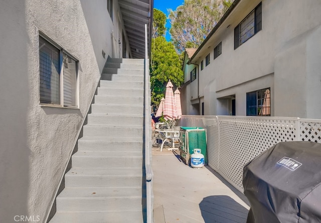 view of patio / terrace featuring stairs, area for grilling, and cooling unit