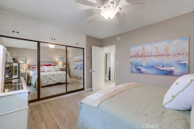 bedroom featuring light wood-type flooring, a closet, and ceiling fan