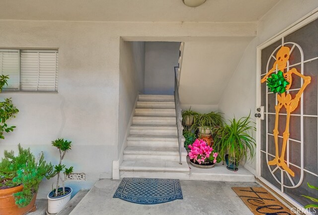 doorway to property with stucco siding