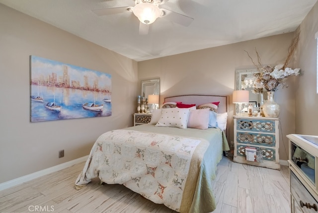 bedroom featuring ceiling fan, baseboards, and wood finished floors