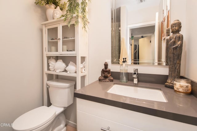 bathroom featuring toilet, visible vents, and vanity