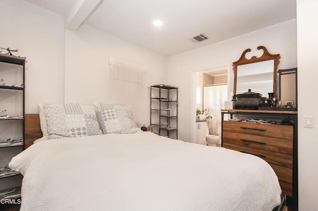 bedroom with beam ceiling, connected bathroom, visible vents, and recessed lighting