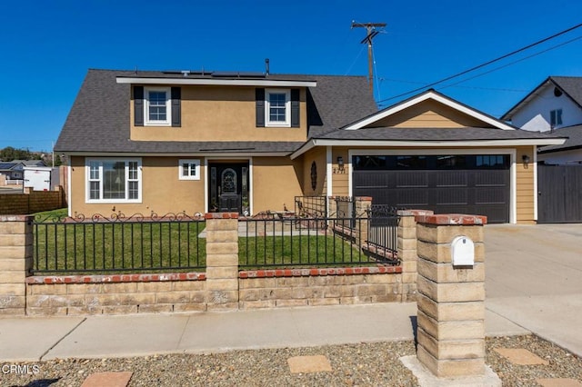 view of front of home with a fenced front yard, stucco siding, roof mounted solar panels, a garage, and a front lawn