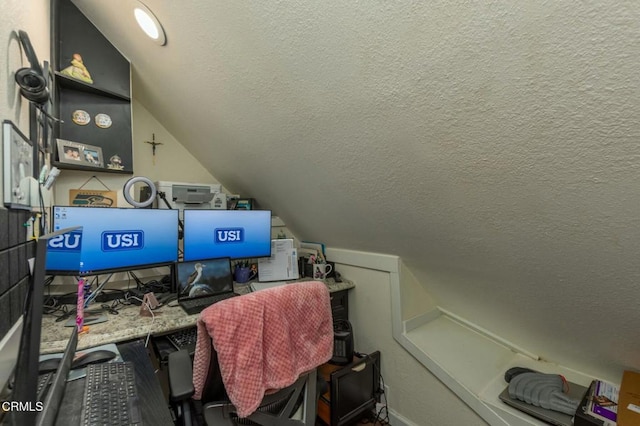 home office with lofted ceiling and a textured ceiling