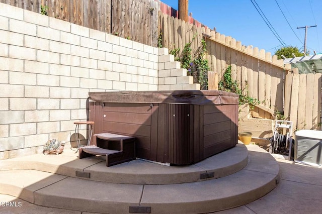 exterior details featuring a fenced backyard and a jacuzzi