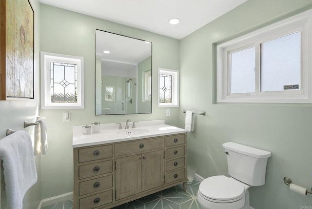 bathroom with tile patterned flooring, a shower with shower door, toilet, vanity, and baseboards