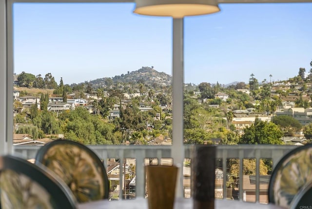 balcony featuring a residential view and a mountain view