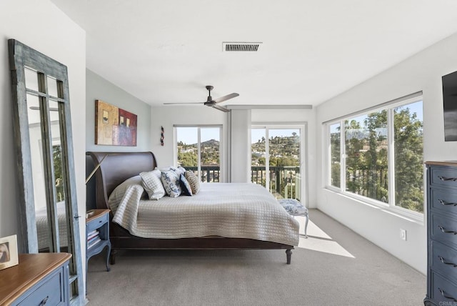 bedroom featuring light carpet, ceiling fan, visible vents, and access to exterior