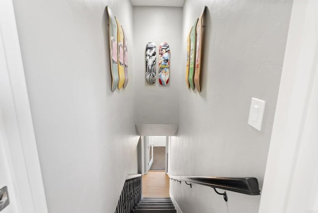 stairway featuring wood finished floors