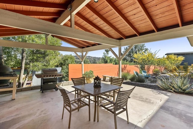 view of patio / terrace with a gazebo, outdoor dining area, area for grilling, and fence