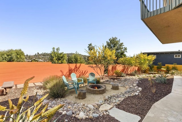 view of patio with a fenced backyard and a fire pit