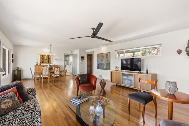 living room with ceiling fan and wood finished floors