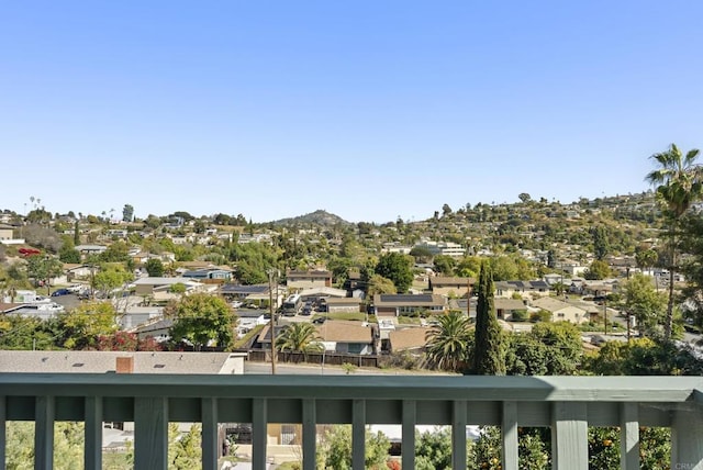 balcony featuring a residential view and a mountain view