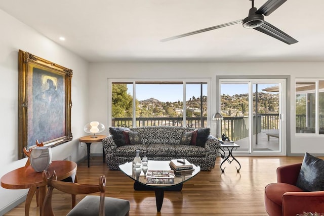 living room with a ceiling fan, wood finished floors, and recessed lighting