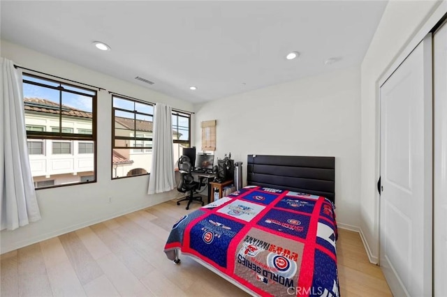 bedroom featuring baseboards, visible vents, wood finished floors, and recessed lighting