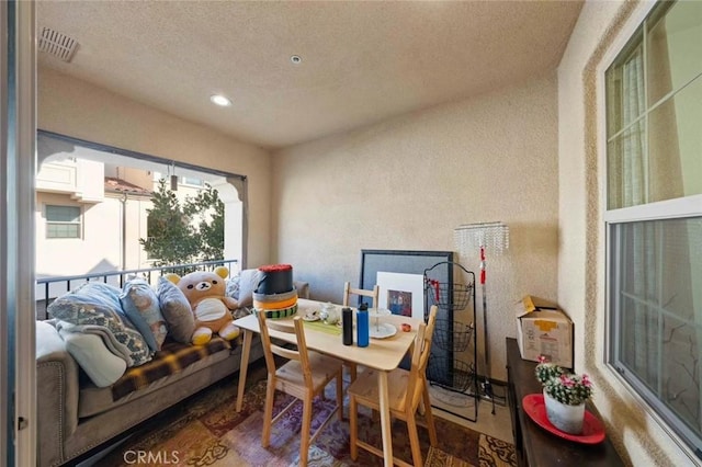 interior space with recessed lighting, visible vents, wood finished floors, and a textured wall