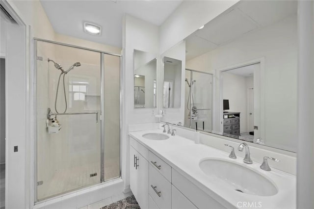 full bathroom featuring a stall shower and a sink