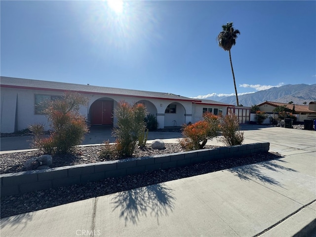 single story home featuring driveway and a mountain view