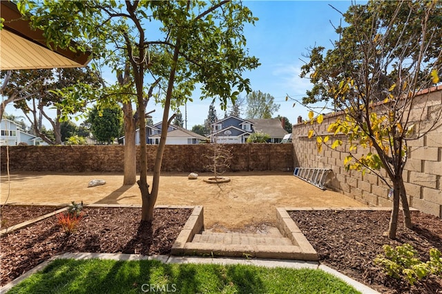 view of yard with a fenced backyard and a residential view