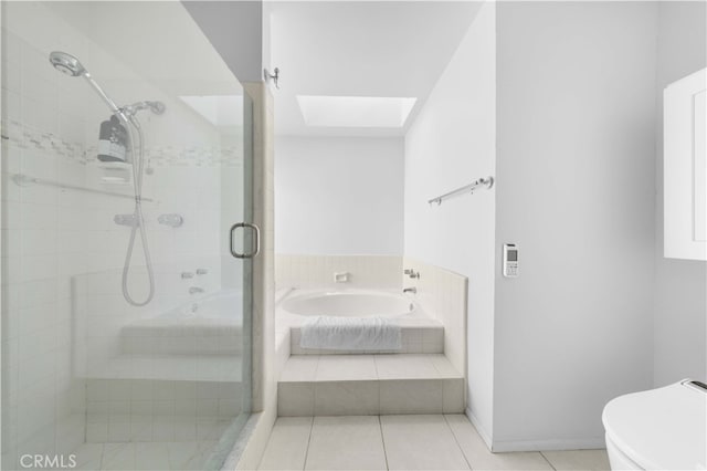 bathroom featuring toilet, a stall shower, tile patterned flooring, and a garden tub