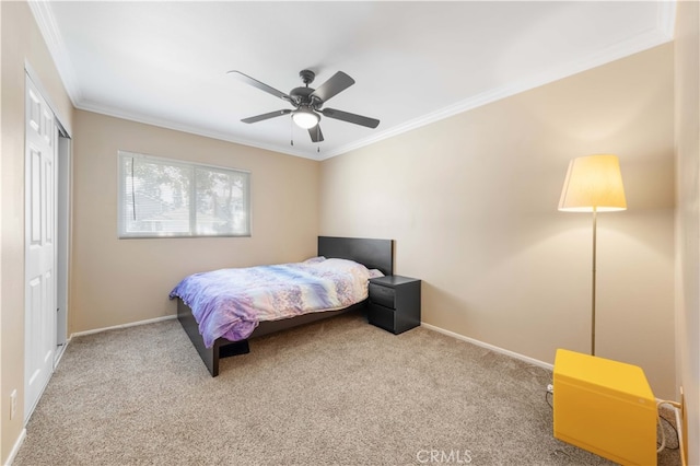 bedroom with a closet, light colored carpet, crown molding, and baseboards