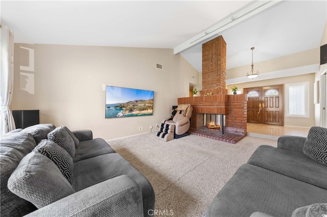 living room with carpet, beam ceiling, visible vents, and a fireplace