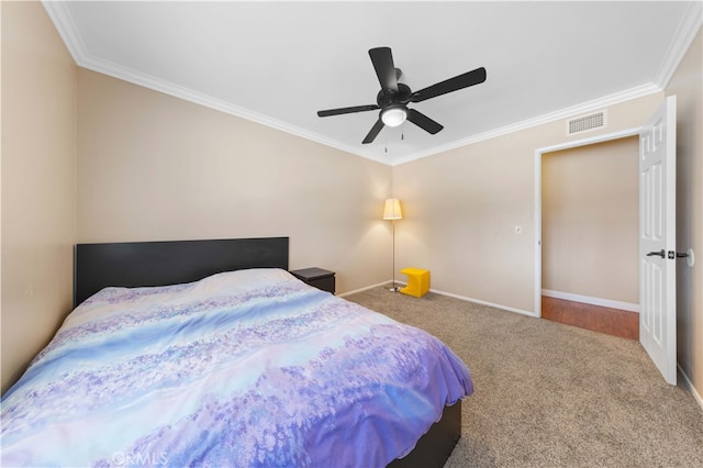 carpeted bedroom with ornamental molding, visible vents, and baseboards