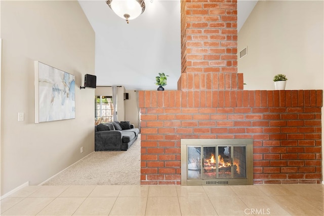 unfurnished living room with carpet, a fireplace, visible vents, high vaulted ceiling, and tile patterned flooring