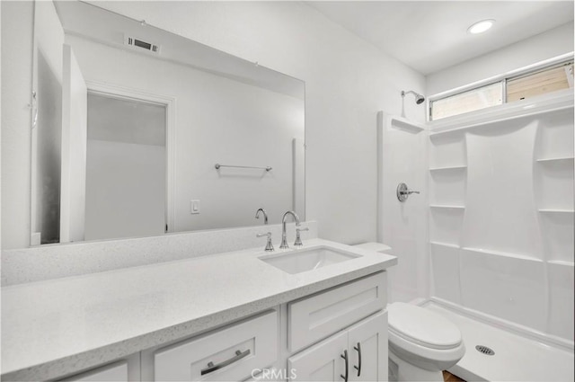 full bathroom with toilet, a shower stall, visible vents, and vanity