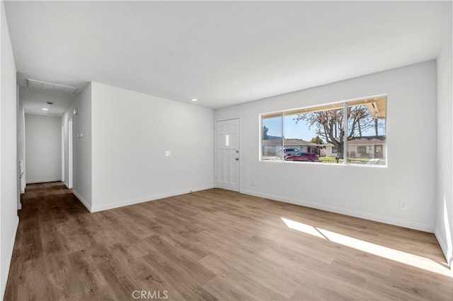 interior space with baseboards and wood finished floors