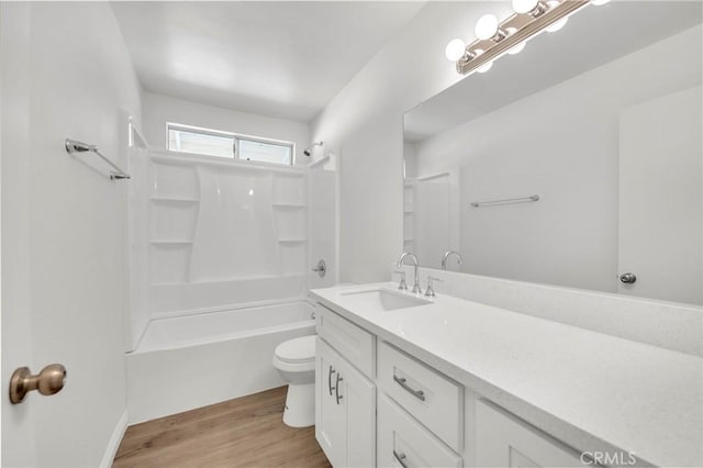 bathroom with shower / bath combination, vanity, toilet, and wood finished floors