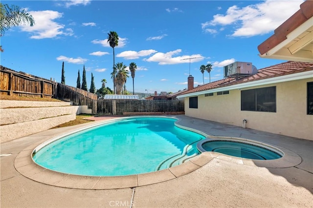 view of swimming pool with central air condition unit, a fenced backyard, and a pool with connected hot tub