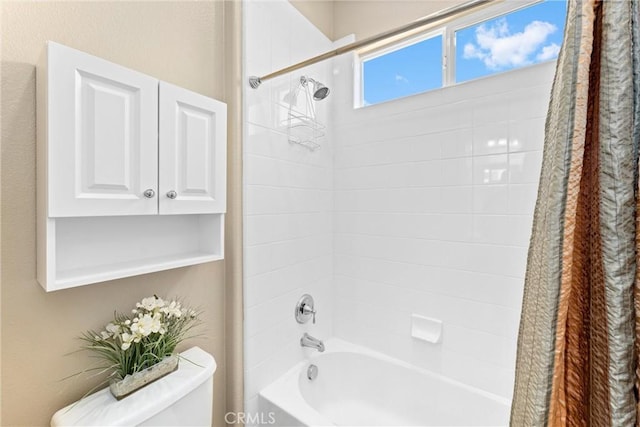 bathroom with shower / bath combo and toilet