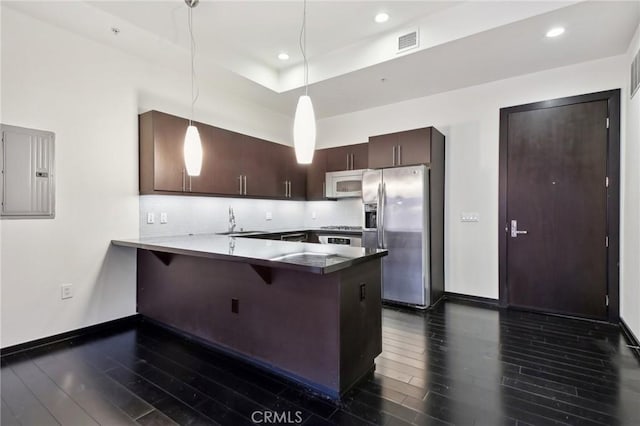 kitchen with stainless steel appliances, a peninsula, visible vents, dark brown cabinets, and electric panel