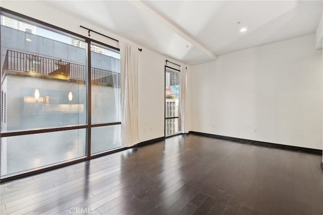 empty room with baseboards and wood finished floors