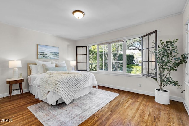 bedroom featuring baseboards and wood finished floors