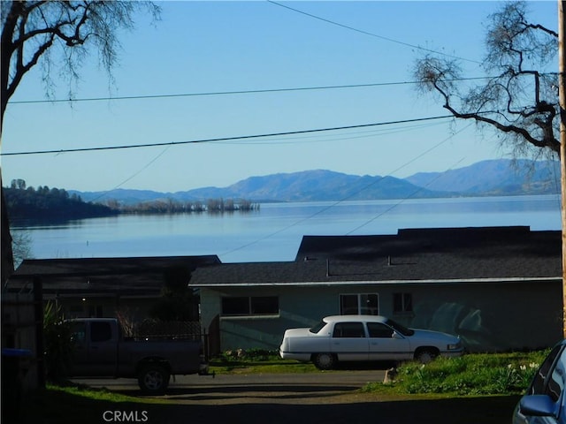 view of front of property with a water and mountain view