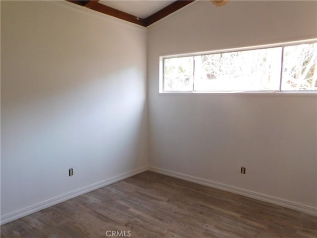 empty room with baseboards and dark wood-style flooring