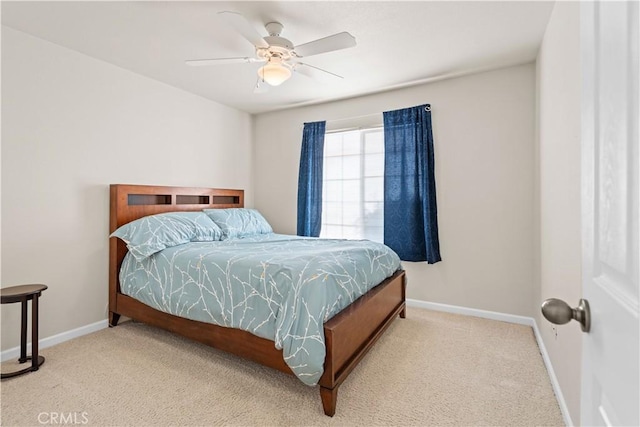 carpeted bedroom featuring baseboards and a ceiling fan