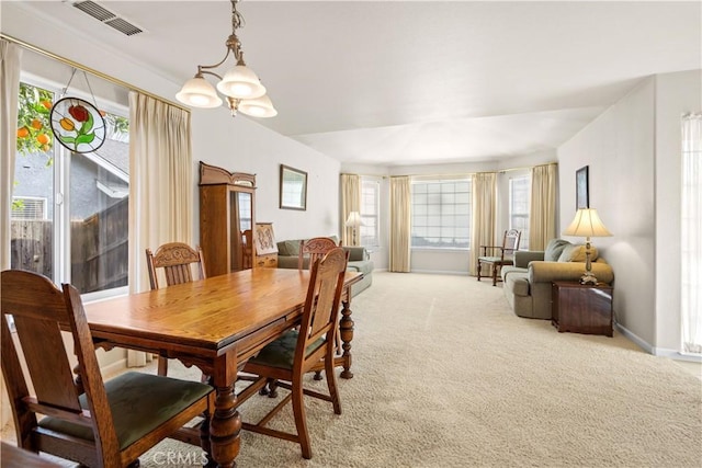 dining room featuring baseboards, an inviting chandelier, visible vents, and light colored carpet