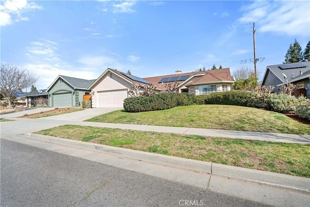 ranch-style house with a garage, stucco siding, concrete driveway, and a front yard