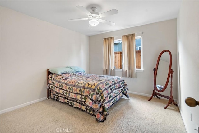 bedroom with light carpet, a ceiling fan, and baseboards