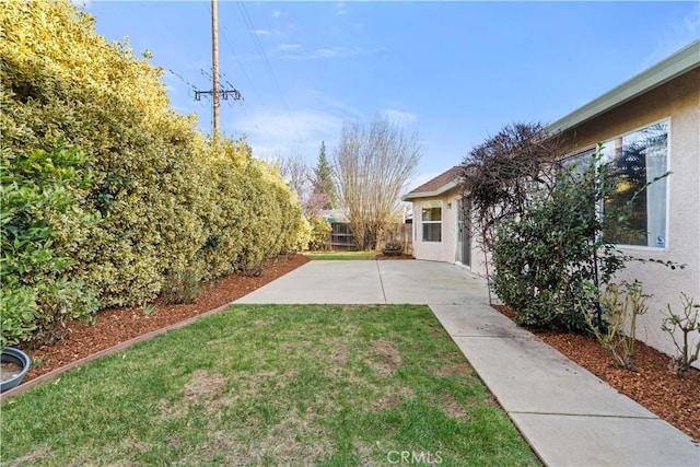 view of yard with fence and a patio