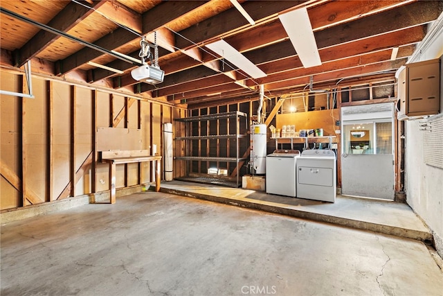 basement featuring a garage, secured water heater, and independent washer and dryer