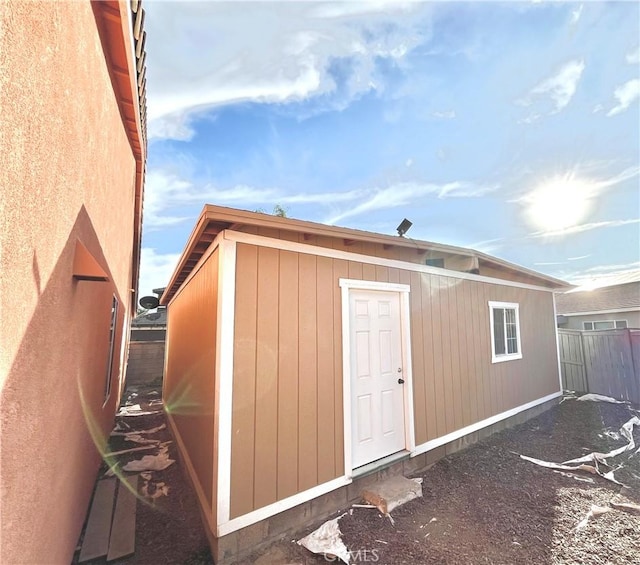 view of outbuilding with fence