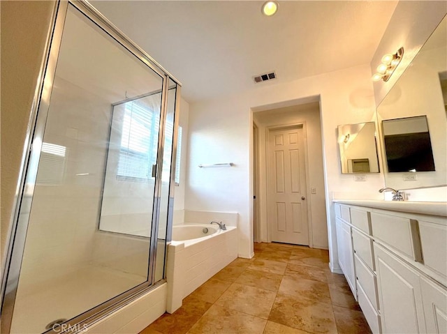 full bathroom featuring vanity, a stall shower, a garden tub, and visible vents