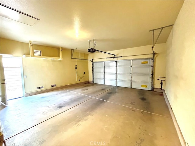 garage with a garage door opener and baseboards