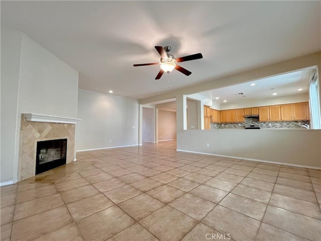 unfurnished living room featuring a premium fireplace, recessed lighting, a ceiling fan, and baseboards