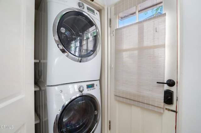 clothes washing area with laundry area and stacked washer / drying machine